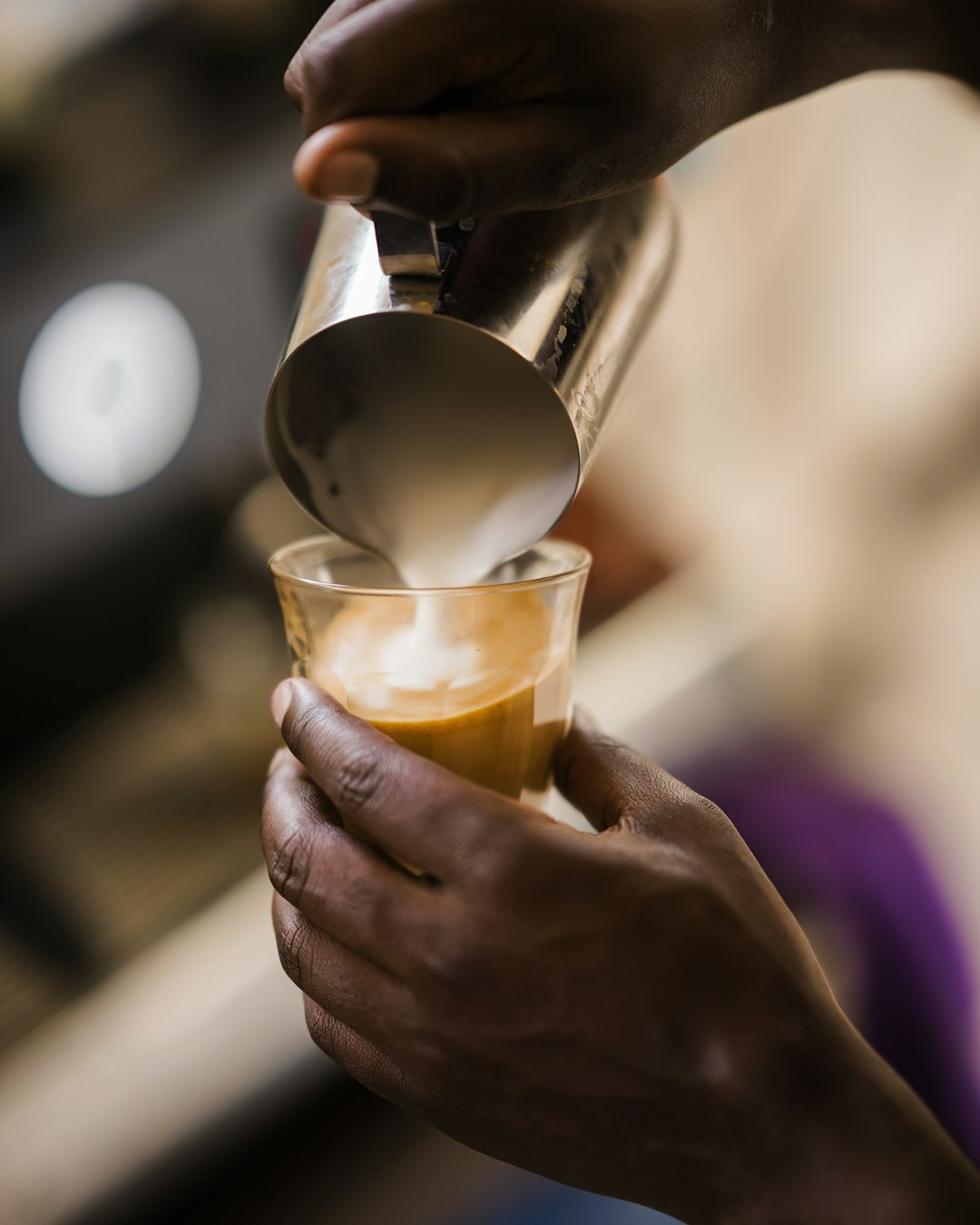 barista-pouring-frothed-milk-into-coffee-nauzp-e-u-u